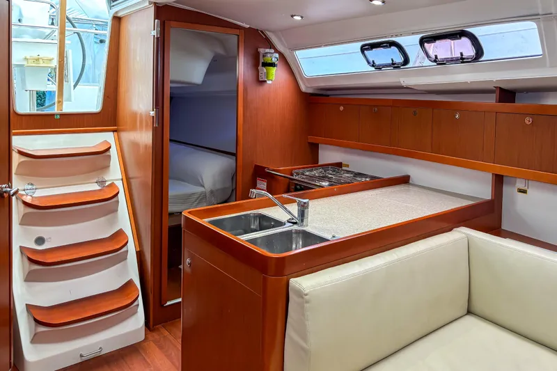 Marley Yacht Photos Pics Interior of 2015 Beneteau Oceanis 37 yacht with modern kitchen and cozy cabin.