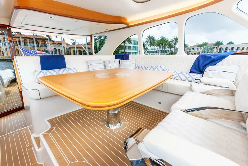 Shaken Not Stirred Yacht Photos Pics Luxurious interior of 2019 Zeelander Z55 yacht with elegant seating and wooden table.