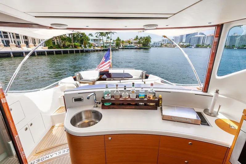 Shaken Not Stirred Yacht Photos Pics Luxurious 2019 Zeelander Z55 yacht interior with bar, overlooking scenic waterfront.