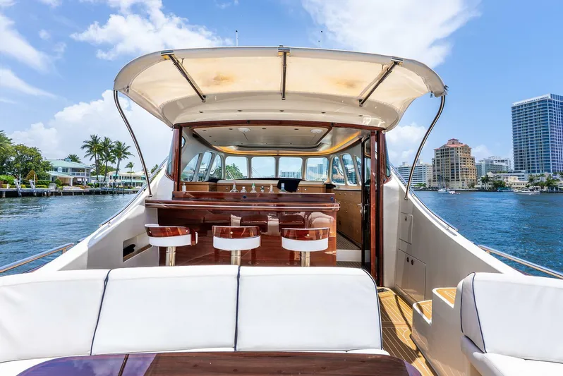 Shaken Not Stirred Yacht Photos Pics Luxurious 2019 Zeelander Z55 yacht interior with bar stools, docked by waterfront cityscape.