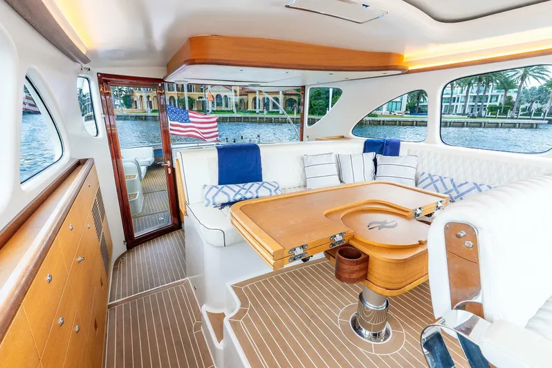 Shaken Not Stirred Yacht Photos Pics Luxurious interior of 2019 Zeelander Z55 yacht with elegant seating and wooden table.
