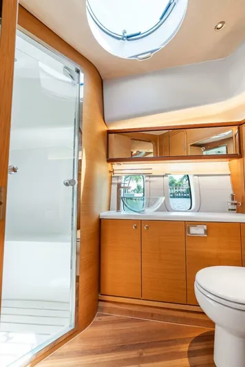 Shaken Not Stirred Yacht Photos Pics Luxurious 2019 Zeelander Z55 yacht bathroom with wood accents and modern fixtures.