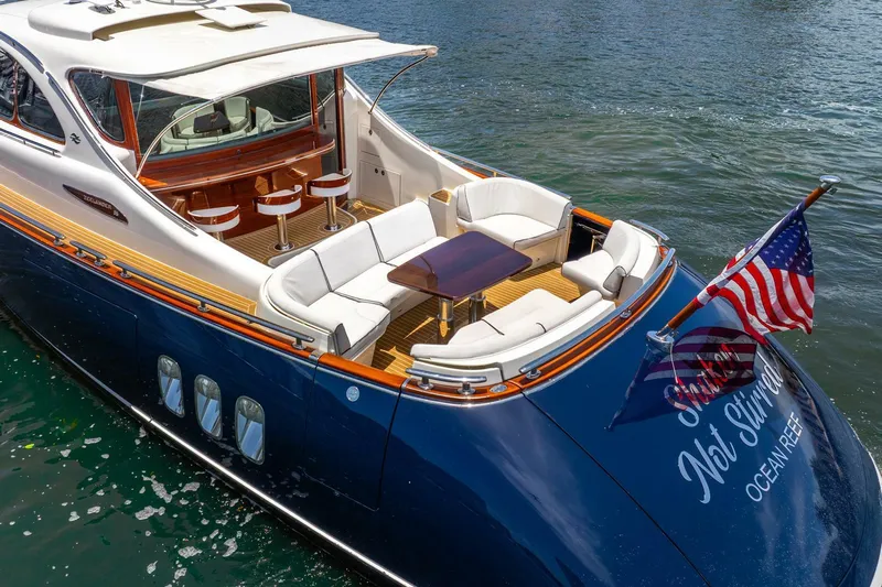 Shaken Not Stirred Yacht Photos Pics Luxurious 2019 Zeelander Z55 yacht with elegant seating and American flag on water.