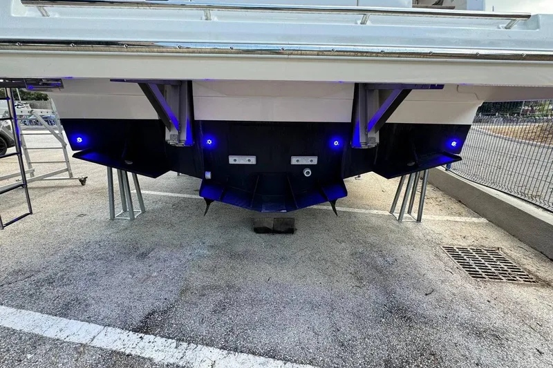  Yacht Photos Pics Rear view of 2026 Prestige F4.9 boat with blue LED lights and support stands.