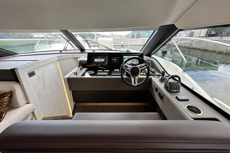 Yacht Photos Pics Interior view of 2026 Prestige F4.9 yacht cockpit with modern controls and steering wheel.