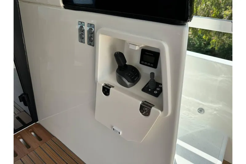  Yacht Photos Pics Control panel of a 2026 Prestige F4.9 yacht, featuring joysticks and digital display.
