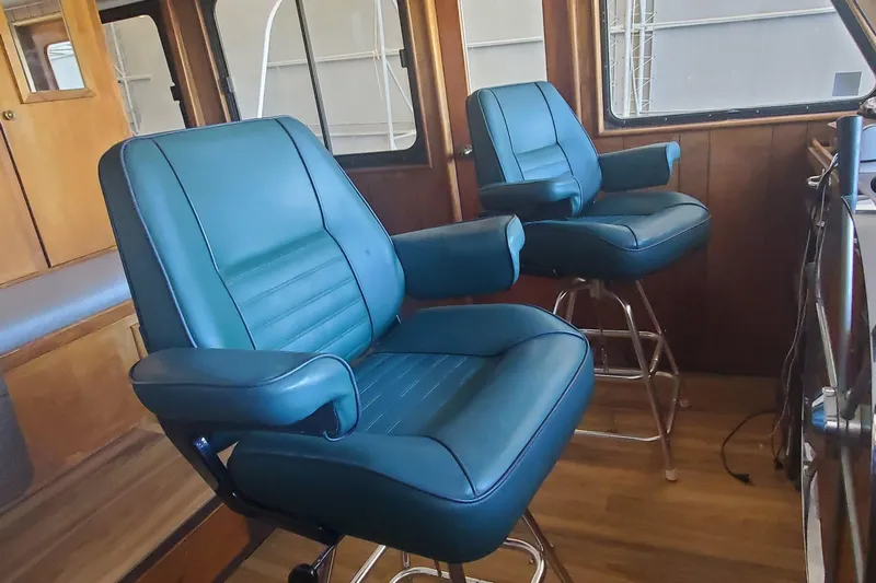 Regal Countess Yacht Photos Pics Interior of 1965 Tacoma Boat Works Bill Garden Motor Yacht with blue captain chairs.