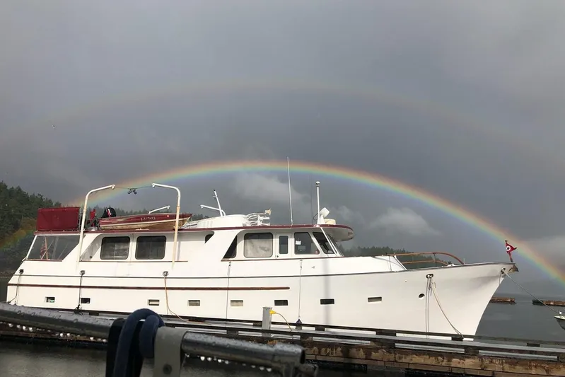 Regal Countess Yacht Photos Pics 1965 Tacoma Boat Works Bill Garden Motor Yacht with rainbow backdrop at dock.