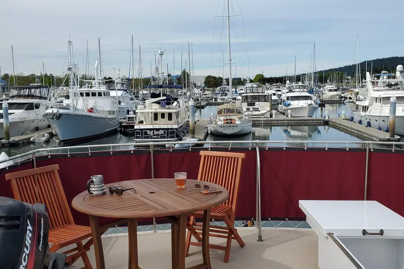 Regal Countess Yacht Photos Pics 1965 Tacoma Boat Works Bill Garden Motor Yacht in marina, with wooden deck furniture.