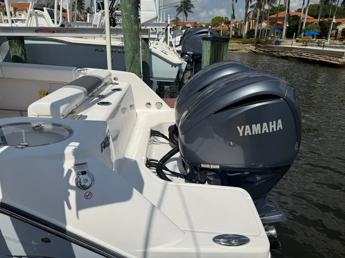 272-203 Brokerage Sebastian Yacht Photos Pics 2023 Robalo R272 Center Console with Yamaha engines docked by the water.