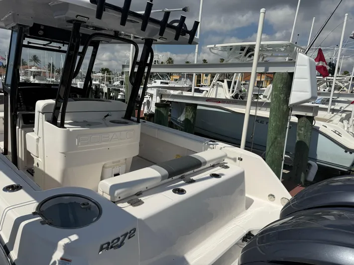 272-203 Brokerage Sebastian Yacht Photos Pics 2023 Robalo R272 Center Console boat docked at marina, showcasing sleek design and spacious deck.