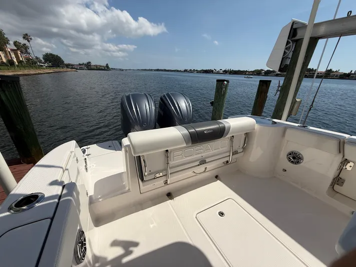 272-203 Brokerage Sebastian Yacht Photos Pics 2023 Robalo R272 Center Console boat with dual engines, docked by a scenic waterfront.