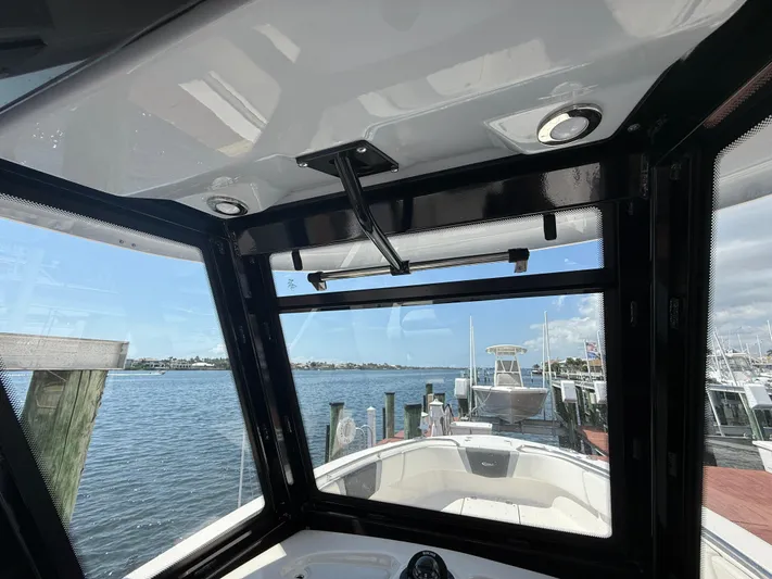 272-203 Brokerage Sebastian Yacht Photos Pics 2023 Robalo R272 Center Console boat interior with waterfront view.