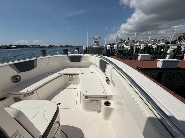 272-203 Brokerage Sebastian Yacht Photos Pics 2023 Robalo R272 Center Console boat docked at marina under clear sky.