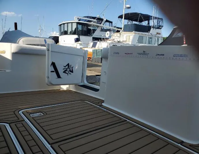  Yacht Photos Pics 2005 Silverton 34 Convertible boat deck with teak flooring and marina background.