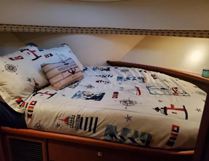 Yacht Photos Pics Cozy cabin bed in 2005 Silverton 34 Convertible with nautical-themed bedding.