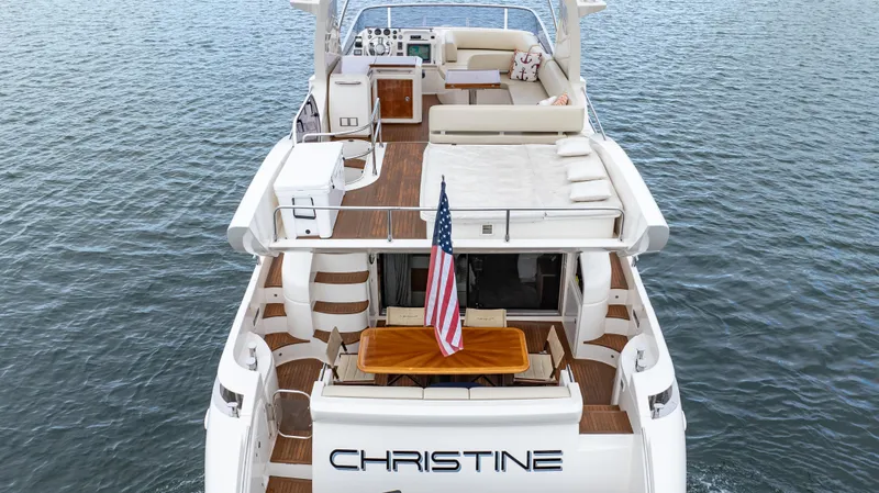 Christine Yacht Photos Pics Azimut 58 Flybridge 2011 yacht with spacious deck and American flag on water.