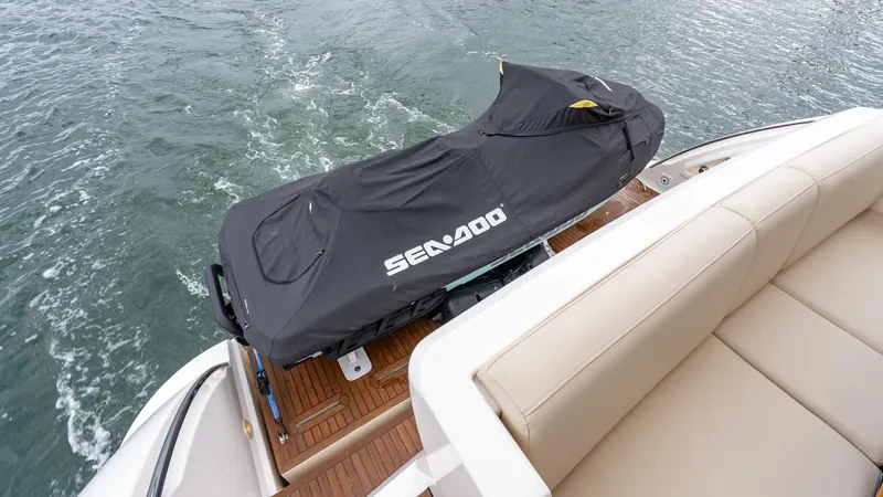 Christine Yacht Photos Pics Azimut 58 Flybridge 2011 with covered Sea-Doo jet ski on deck, cruising on water.