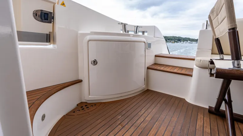 Christine Yacht Photos Pics 2011 Azimut 58 Flybridge yacht deck with wooden flooring and seating area.