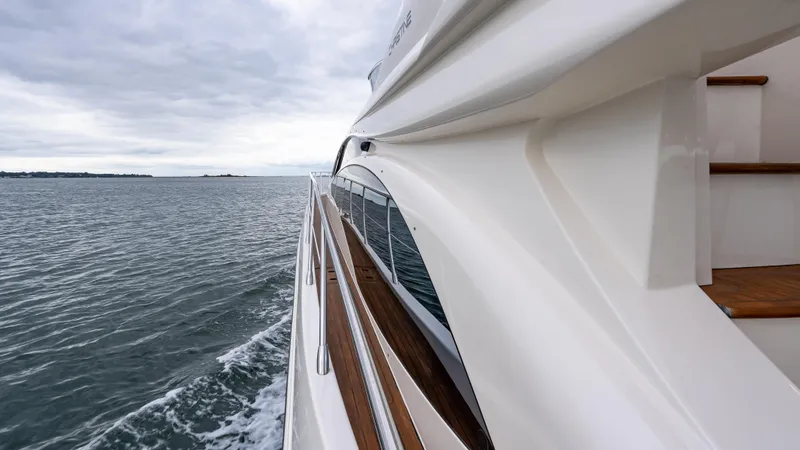 Christine Yacht Photos Pics Azimut 58 Flybridge yacht cruising on open water, side view, 2011 model.