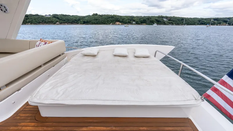 Christine Yacht Photos Pics Luxurious sunbed on 2011 Azimut 58 Flybridge yacht, overlooking serene waters.