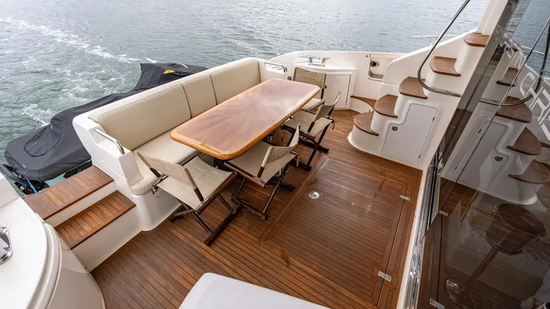 Christine Yacht Photos Pics Luxurious 2011 Azimut 58 Flybridge yacht with elegant outdoor seating and wooden deck.