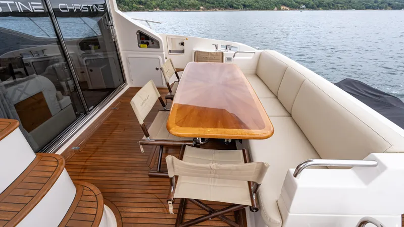 Christine Yacht Photos Pics Luxurious 2011 Azimut 58 Flybridge yacht with elegant outdoor seating and dining area.