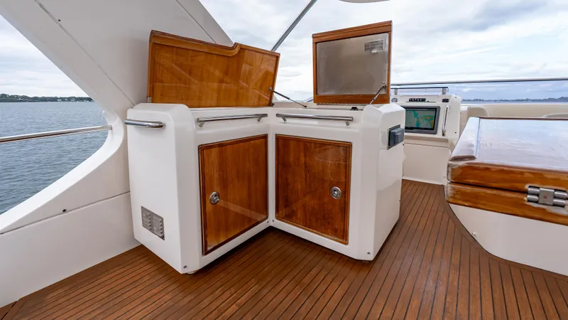 Christine Yacht Photos Pics Flybridge of 2011 Azimut 58 yacht with wooden cabinetry and ocean view.