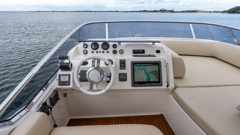 Christine Yacht Photos Pics Flybridge helm of 2011 Azimut 58, featuring navigation controls and panoramic water view.