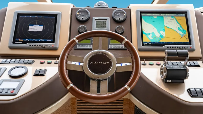 Christine Yacht Photos Pics Cockpit of 2011 Azimut 58 Flybridge yacht with navigation screens and controls.