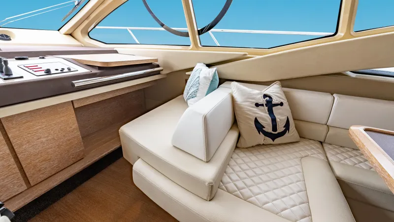 Christine Yacht Photos Pics Luxurious interior of 2011 Azimut 58 Flybridge yacht with plush seating and nautical decor.
