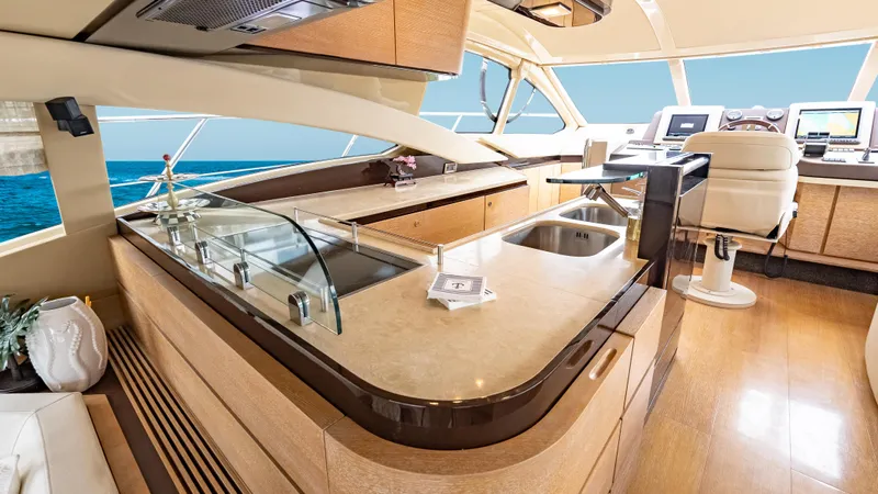 Christine Yacht Photos Pics Luxurious interior of 2011 Azimut 58 Flybridge yacht with modern kitchen and helm.