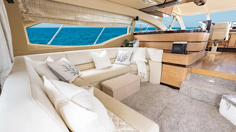 Christine Yacht Photos Pics Luxurious interior of 2011 Azimut 58 Flybridge yacht with elegant seating and ocean view.