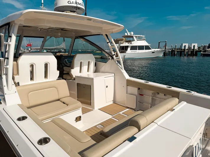 Adios Yacht Photos Pics 2018 Pursuit DC 325 Dual Console boat docked, featuring spacious seating and modern design.
