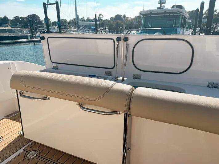 Adios Yacht Photos Pics 2018 Pursuit DC 325 Dual Console boat interior with seating and marina view.