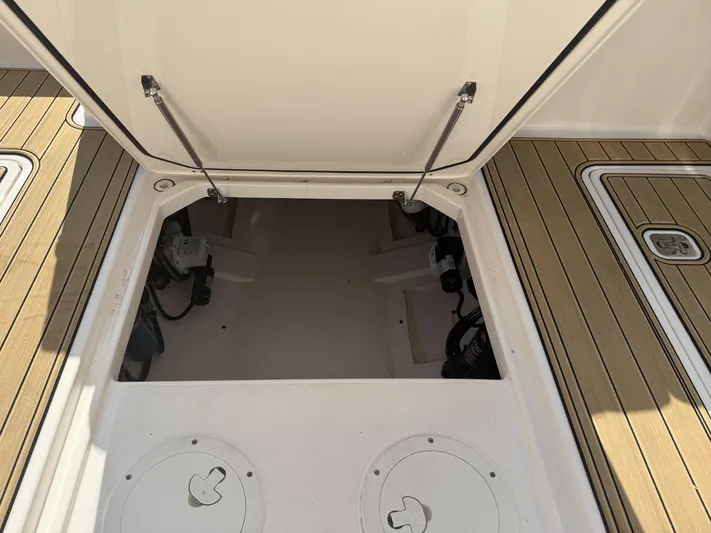 Adios Yacht Photos Pics Open storage compartment on 2018 Pursuit DC 325 Dual Console boat deck.