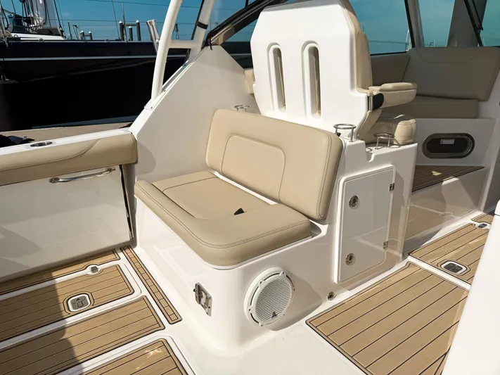 Adios Yacht Photos Pics 2018 Pursuit DC 325 Dual Console interior with beige seating and teak flooring.