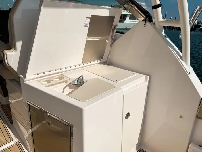 Adios Yacht Photos Pics 2018 Pursuit DC 325 Dual Console boat with open sink and storage area.