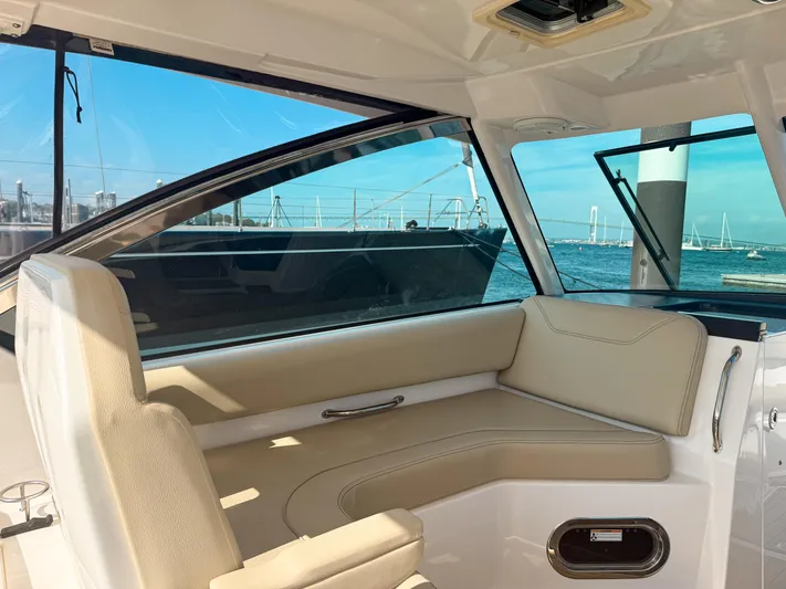 Adios Yacht Photos Pics Interior of 2018 Pursuit DC 325 Dual Console boat with beige seating and ocean view.