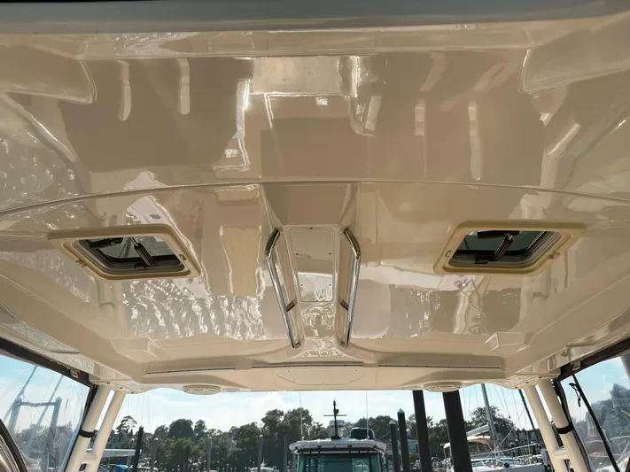 Adios Yacht Photos Pics 2018 Pursuit DC 325 Dual Console boat ceiling with hatches and sleek design.