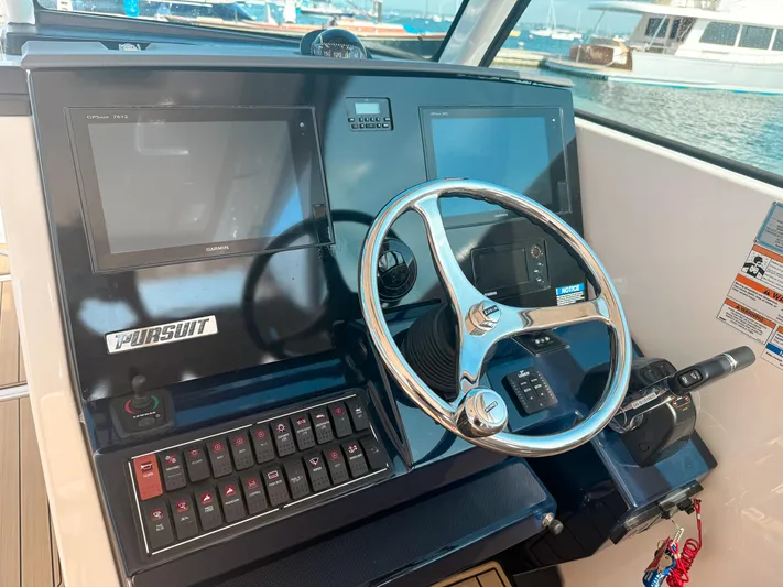 Adios Yacht Photos Pics 2018 Pursuit DC 325 Dual Console helm with Garmin displays and steering wheel.