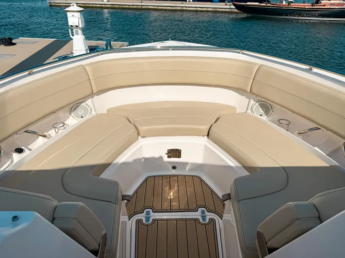 Adios Yacht Photos Pics 2018 Pursuit DC 325 Dual Console boat with beige seating and teak flooring at a marina.