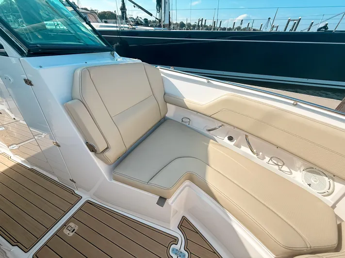 Adios Yacht Photos Pics Luxurious seating on 2018 Pursuit DC 325 Dual Console boat, featuring beige upholstery and teak flooring.