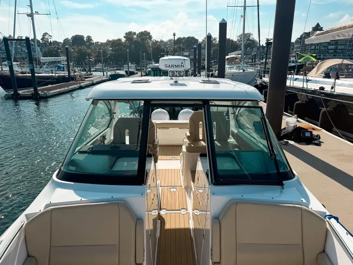 Adios Yacht Photos Pics 2018 Pursuit DC 325 Dual Console boat docked at marina, featuring spacious seating and modern design.