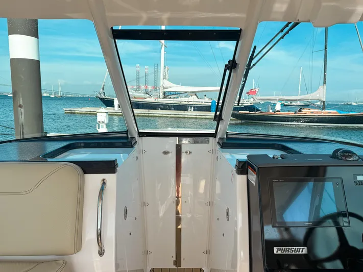 Adios Yacht Photos Pics 2018 Pursuit DC 325 Dual Console boat interior with marina view.