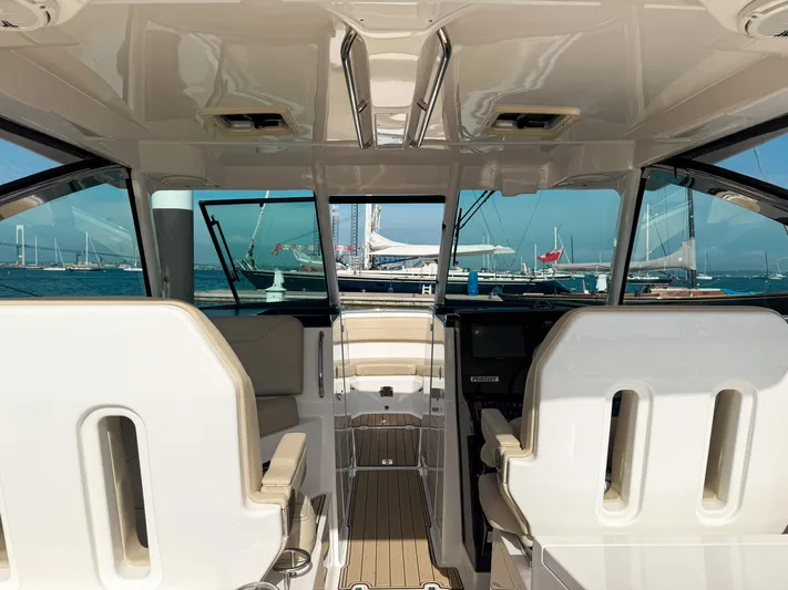 Adios Yacht Photos Pics 2018 Pursuit DC 325 Dual Console interior with ocean view and docked boats.