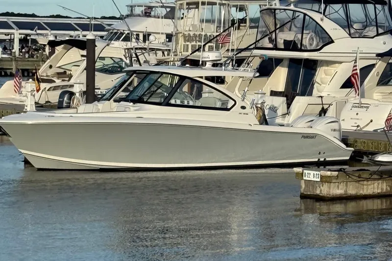  Yacht Photos Pics 2024 Pursuit DC 306 Dual Console boat docked at marina with other yachts.