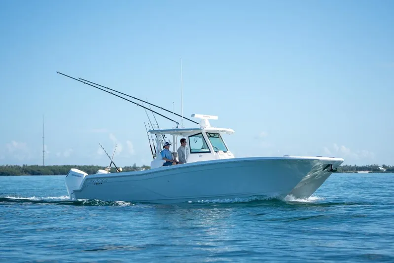  Yacht Photos Pics 2025 Caymas 34 CT boat cruising on open water under clear blue sky.