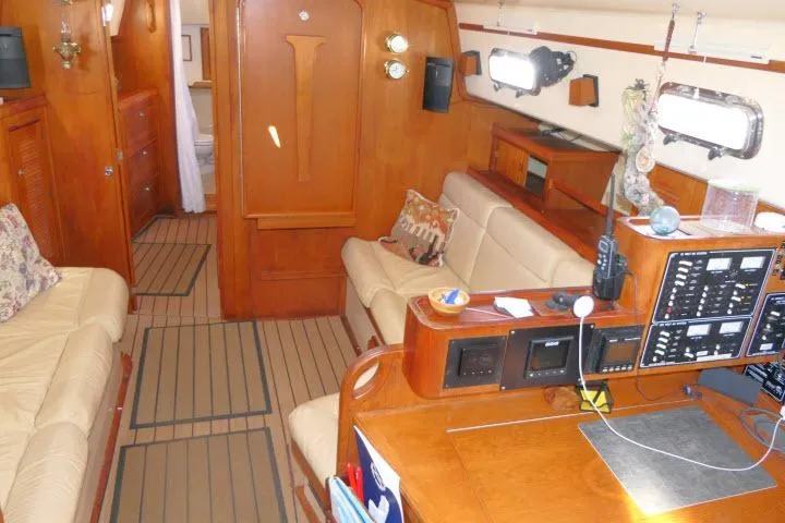 Wild Blue Yacht Photos Pics Interior of 1999 Island Packet 45 sailboat with wood finish and navigation equipment.