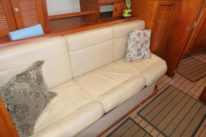 Wild Blue Yacht Photos Pics Interior of 1999 Island Packet 45 yacht with beige leather seating and decorative pillows.